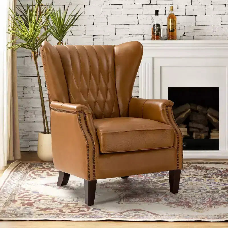 Poltrona Valerius in vera pelle con finiture borchiate e gambe in legno massello | HULALA HOME