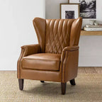 Poltrona Valerius in vera pelle con finiture borchiate e gambe in legno massello | HULALA HOME