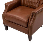 Poltrona Valerius in vera pelle con finiture borchiate e gambe in legno massello | HULALA HOME