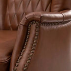 Poltrona Valerius in vera pelle con finiture borchiate e gambe in legno massello | HULALA HOME