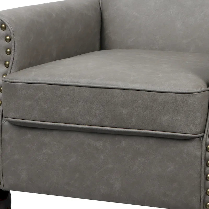 Poltroncina in PU con braccioli arrotolati e finiture borchiate